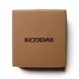a small cardboard box sits open and has a red kodak logo
