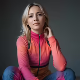 a blond woman sitting in the middle of her pants