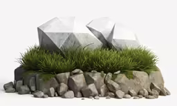 two concrete sculptures are sitting in grass near some rocks