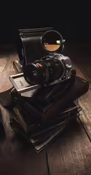 a photo camera on top of a stack of books