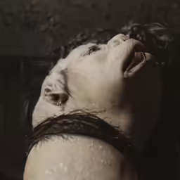 the person has their mouth open as if in deep water