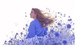 a woman walks through flowers next to the sky