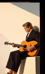 a man playing guitar on a wall