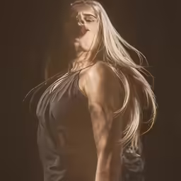 a person with long hair posing for the camera