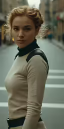 a woman in beige shirt standing on street next to buildings