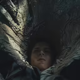 a person laying in a blanket next to each other