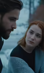 a woman staring at something and a man looking at her with eyes closed