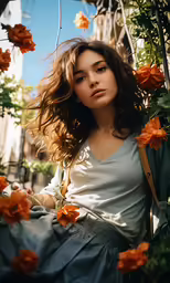 a woman is sitting under a tree with flowers in her hair