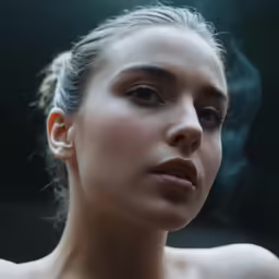 a beautiful woman smoking a cigarette in the dark