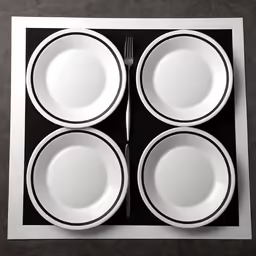 white dishes and fork lie on black plate