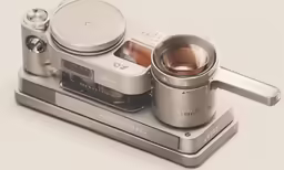 an old, antique camera sits on a metal stand