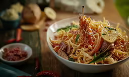 a pasta dish with seafood on top and other vegetables