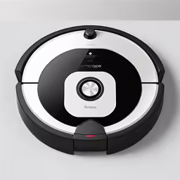 the robotic vacuum is on a white wall