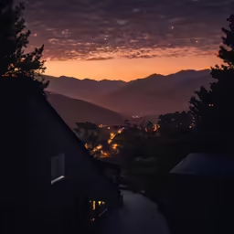 a view of some hills and houses at night