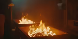 a very big fire pit in the middle of a dark room