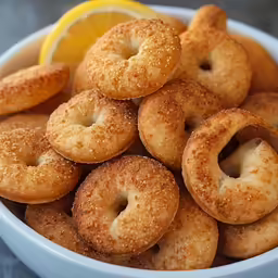 small donuts placed in a bowl with a lemon