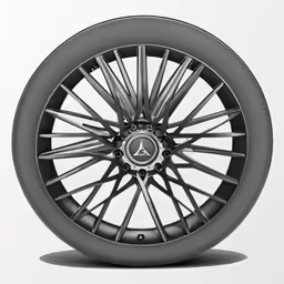 a black mercedes tire sits on a gray surface