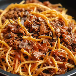 a pan full of noodles and beef stir fry