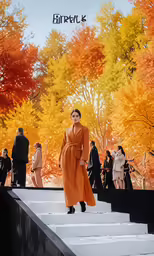 a woman in an orange coat stands on steps with a painting in the background