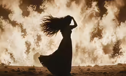 a woman standing in front of a large cloud of smoke