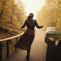 a young woman is walking down the road in a skirt