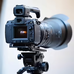 a video camera is on a tripod with the view of the ground