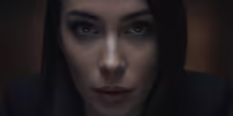 the beautiful female with a dark - brown jacket and lipstick