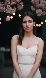 a woman posing for the camera with some lights in the background