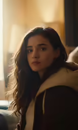 a girl sitting on a couch looking at something