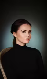 a woman sitting in a chair wearing a black dress