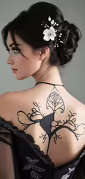 this is a woman with back tattoos and an elegant dress