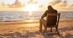 a man sitting on top of a beach chair