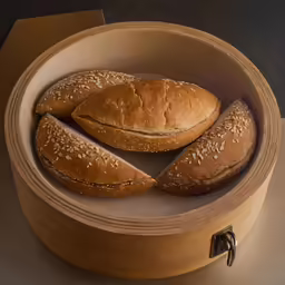 a wooden container with bread and two loaves