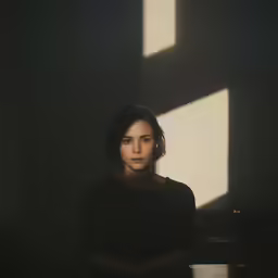 a woman that is sitting in the dark