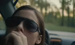 a woman with sun glasses is looking up