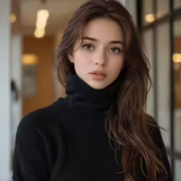 a girl in a black sweater posing for a photo