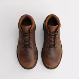 a pair of brown boots with black outs on a white surface