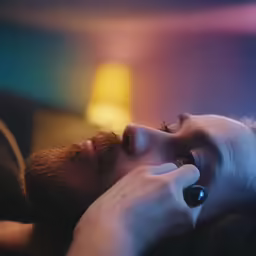 there is a man laying next to a woman with a watch