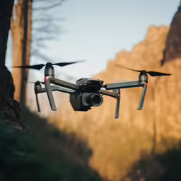 a black remote controlled camera flying over a tree
