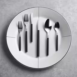 six black and white utensils arranged on a plate