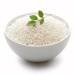 a bowl with some water beads and a plant in it