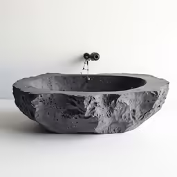 there is a rock sink with a faucet at the top