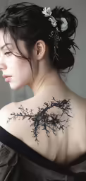 a woman with her back turned to show tattoos