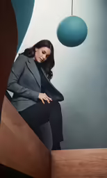 the woman is sitting on top of a stair