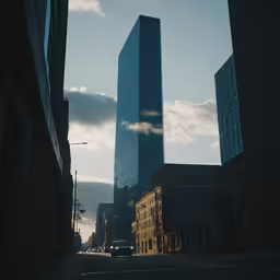 an urban view with tall buildings and a car moving through