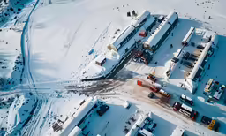 an aerial view shows a small town in the snow