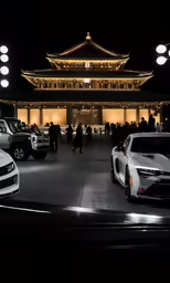 there are cars parked outside a chinese temple