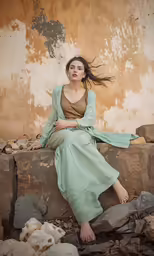 woman posing in front of building with water