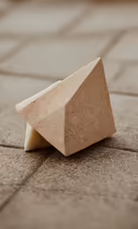 a sculpture on the ground with two pieces of concrete
