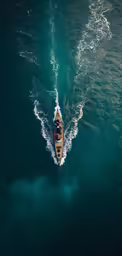 an aerial shot of a long boat in the water